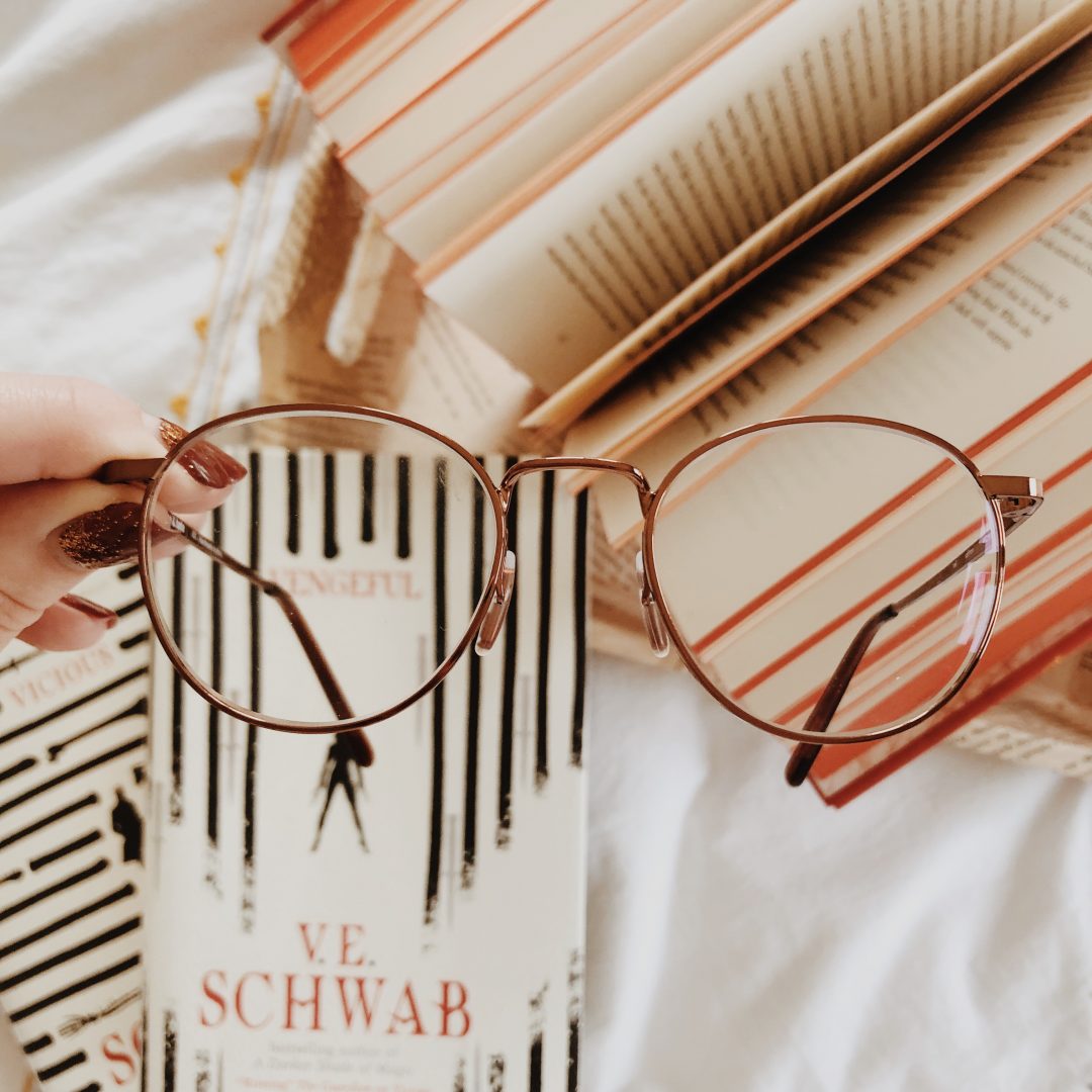 V.E. Schwab books with glasses